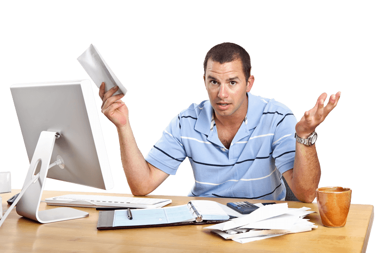Frustrated man at computer holding bill in hand and bills all over desk